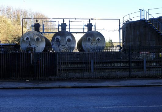 faces painted on cylinders